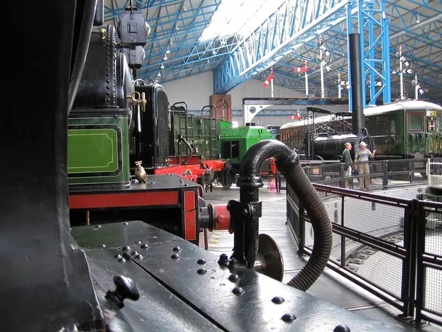 In this image there are train engines in the go down. At the top there are so many iron rods. On...