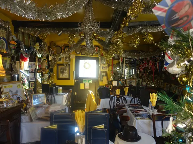 In this picture there is a room in which some chairs and tables are there in the room is decorated...