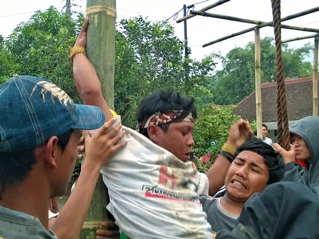 In the picture,some people are performing an activity with bamboo sticks and the crowd is watching...