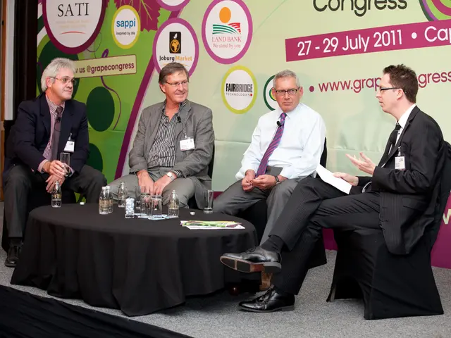 This picture shows four people seated on the chairs And speaking with each other.