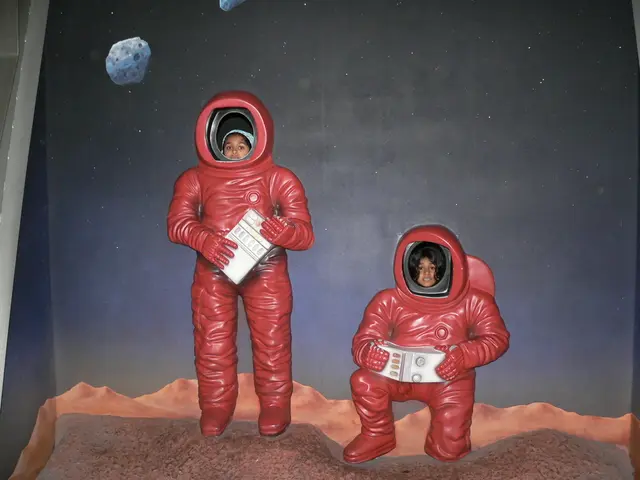 In the foreground of the picture there is a poster of astronauts, in the faces of the astronauts...