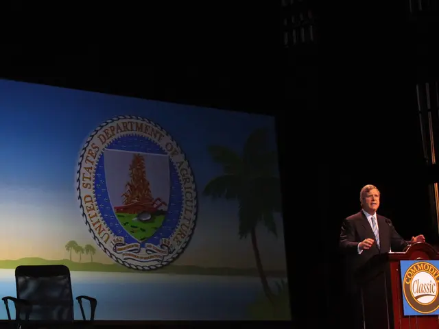 The man in the white shirt and black blazer is standing in front of the podium. I think he is...