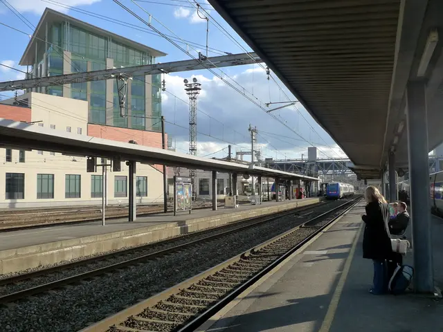 In this image on the right side there are persons standing and sitting and there is a train. There...